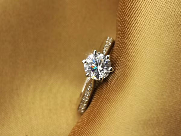 My Store solitaire engagement ring with a brilliant center stone and pavé accents on a polished silver band